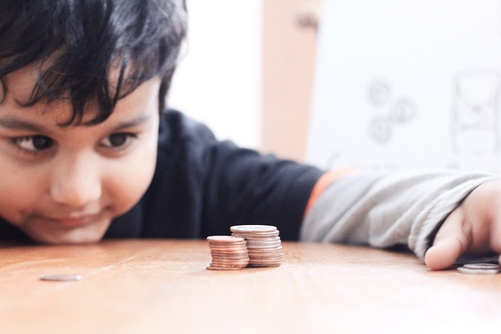 kid counting his $5.00 college fund